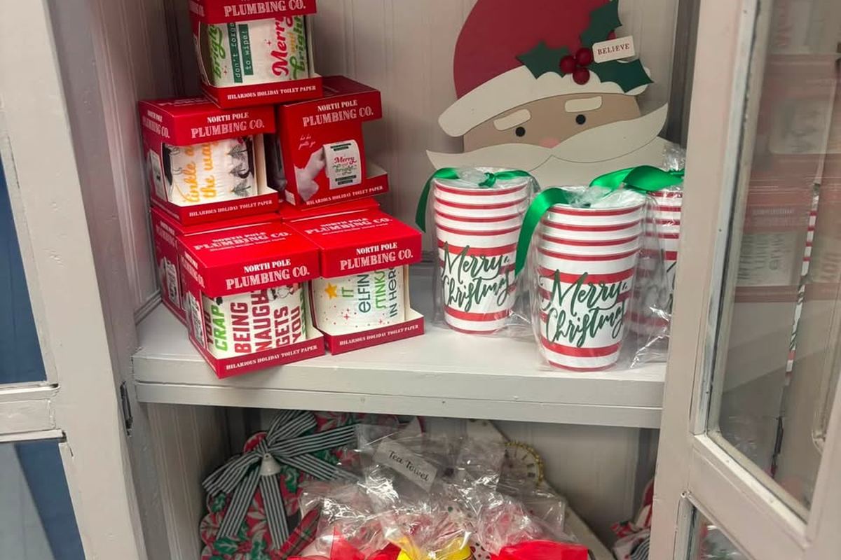 A cabinet of holiday cups, novelty gifts and Christmas tea towels
